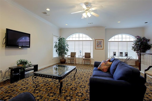 living room with baseboards, visible vents, and crown molding