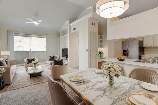 dining space featuring lofted ceiling, visible vents, and crown molding