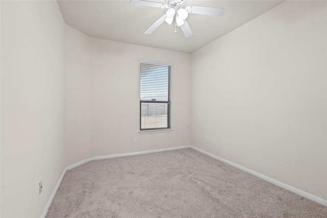 unfurnished room featuring carpet, a ceiling fan, and baseboards