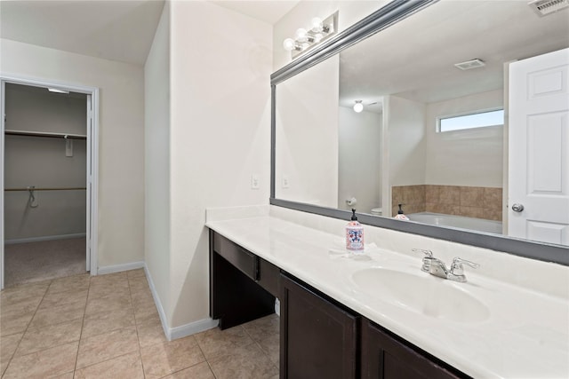 full bathroom with tile patterned flooring, visible vents, vanity, and baseboards