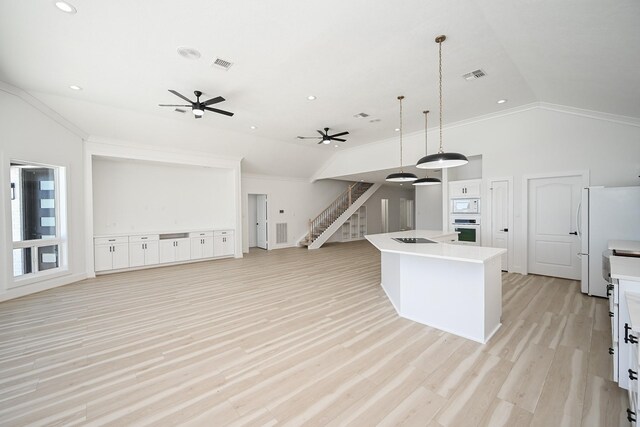 kitchen featuring white appliances, visible vents, vaulted ceiling, and open floor plan