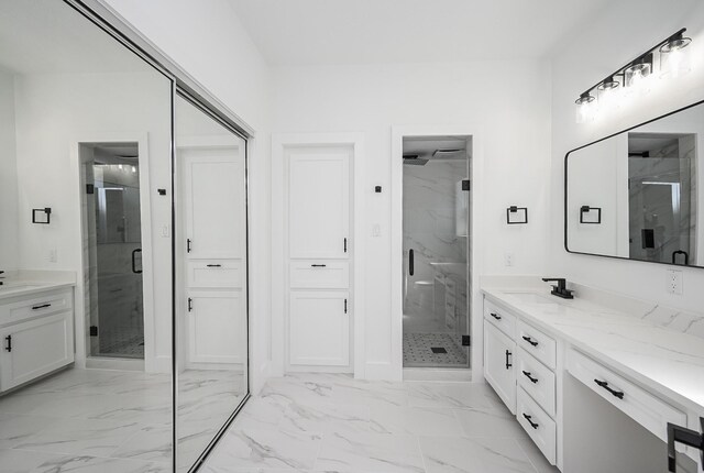 full bath featuring marble finish floor, a marble finish shower, and vanity