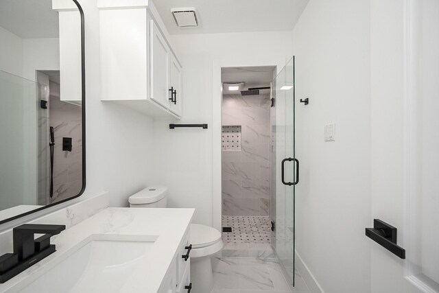 bathroom featuring marble finish floor, a marble finish shower, visible vents, toilet, and vanity