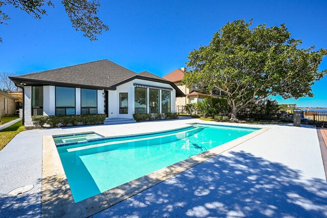 view of swimming pool with a pool with connected hot tub and a patio