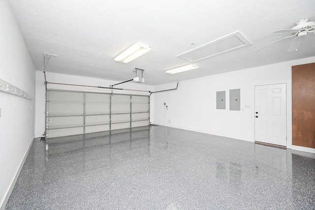 garage featuring a garage door opener, electric panel, and baseboards