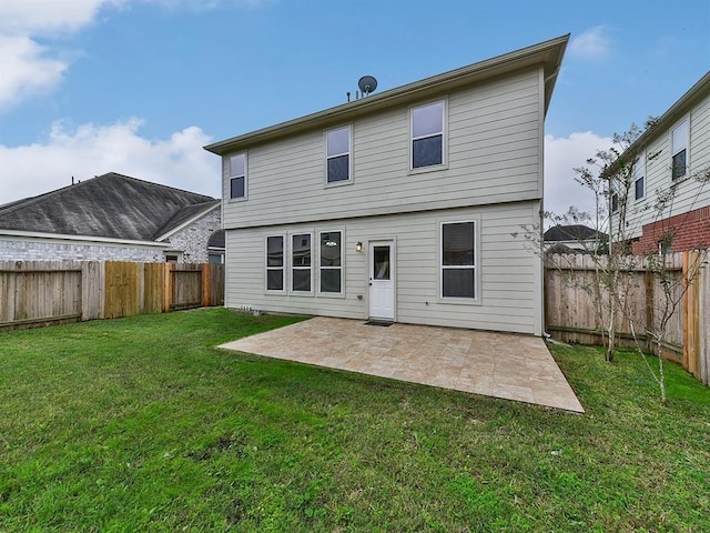 rear view of property with a patio, a lawn, and a fenced backyard