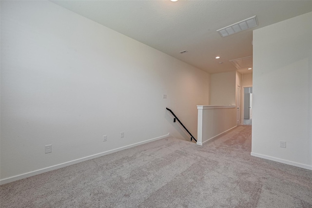 unfurnished room with attic access, baseboards, visible vents, carpet flooring, and recessed lighting