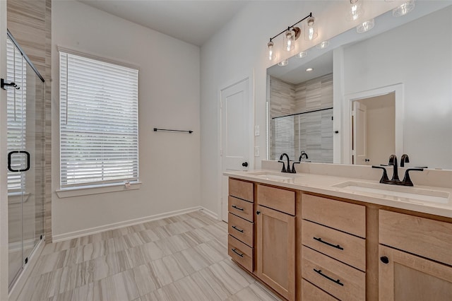 bathroom with a stall shower, a sink, and double vanity