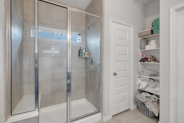 full bathroom with a stall shower and tile patterned floors