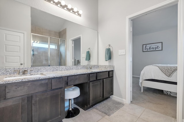 full bath featuring tile patterned floors, a sink, a shower stall, and double vanity