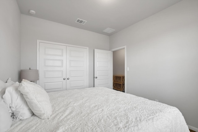 bedroom with a closet and visible vents