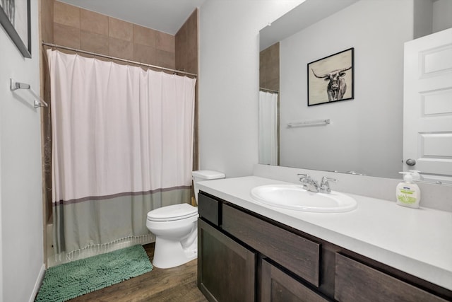 bathroom featuring shower / bathtub combination with curtain, vanity, toilet, and wood finished floors