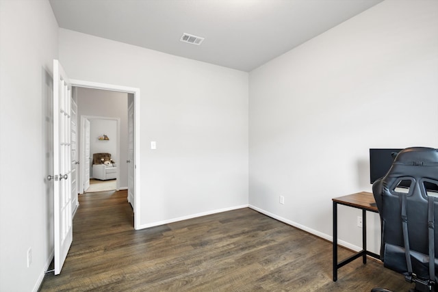 office space featuring visible vents, baseboards, and wood finished floors