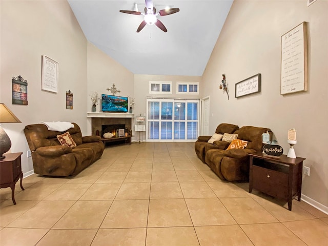 living room featuring a ceiling fan, visible vents, a fireplace, and light tile patterned floors