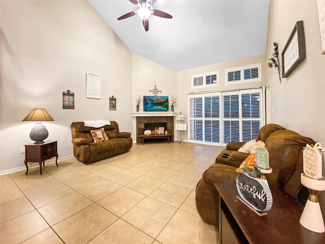 living area with high vaulted ceiling, visible vents, a tiled fireplace, and light tile patterned floors