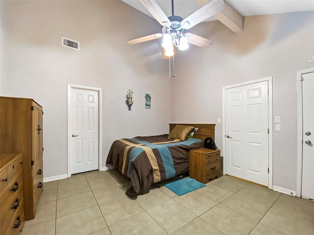 bedroom with light tile patterned floors, high vaulted ceiling, and visible vents