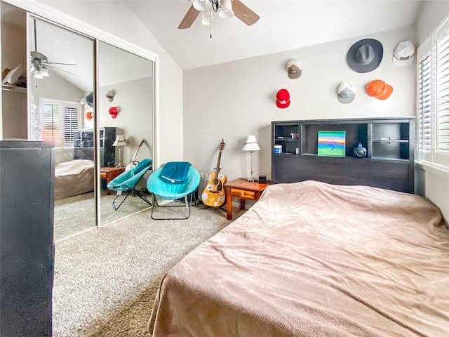 bedroom featuring vaulted ceiling, multiple windows, carpet, and a closet