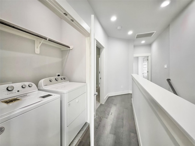 clothes washing area with recessed lighting, visible vents, wood finished floors, washer and dryer, and laundry area