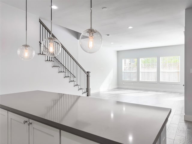 stairway featuring baseboards and recessed lighting