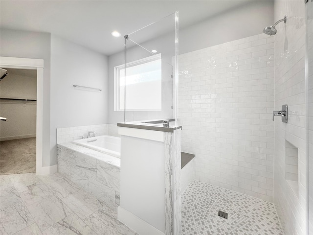 full bath featuring a walk in closet, marble finish floor, tiled shower, and a bath