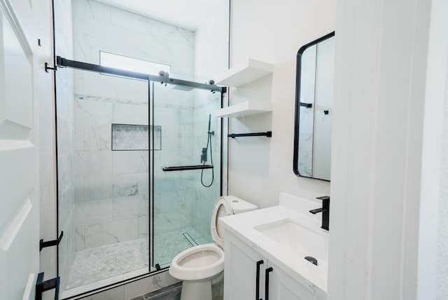 bathroom with vanity, a marble finish shower, and toilet