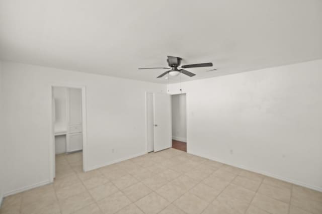 unfurnished bedroom with ceiling fan and baseboards