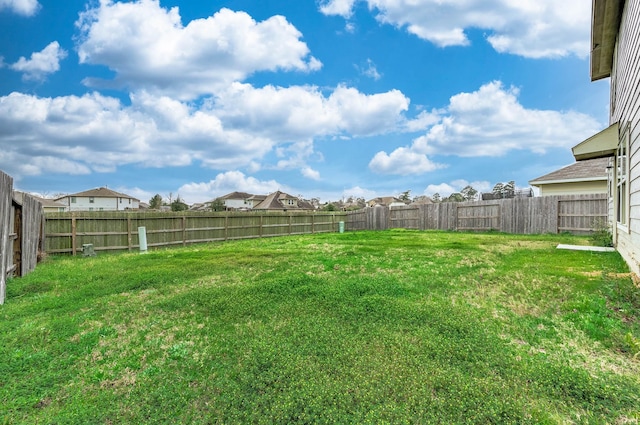 view of yard with a fenced backyard