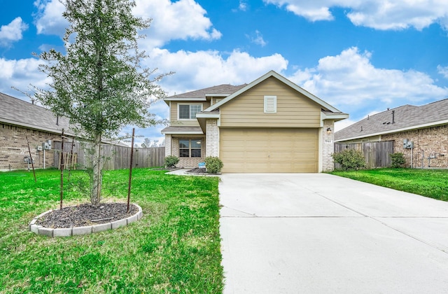 view of front of property featuring brick siding, concrete driveway, an attached garage, fence, and a front yard