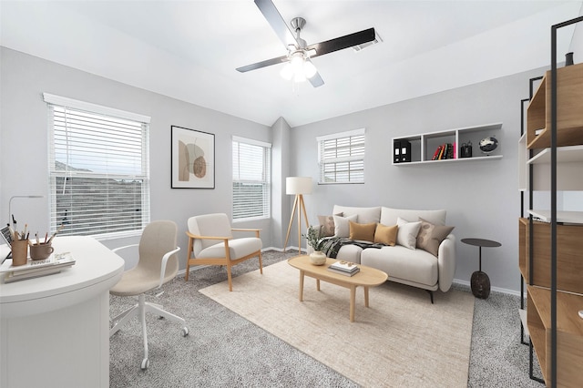 living area with carpet, visible vents, baseboards, and a ceiling fan