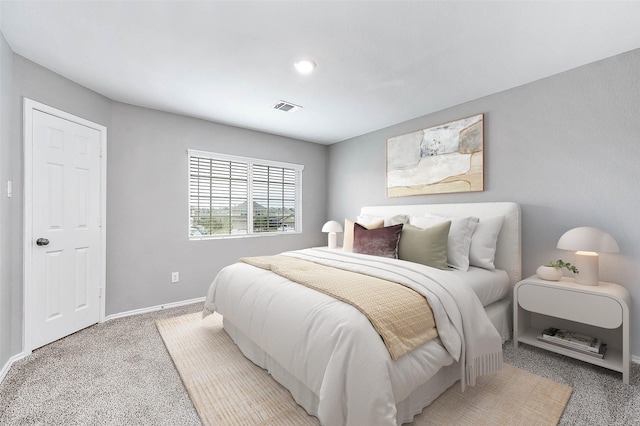 bedroom with light colored carpet, visible vents, and baseboards