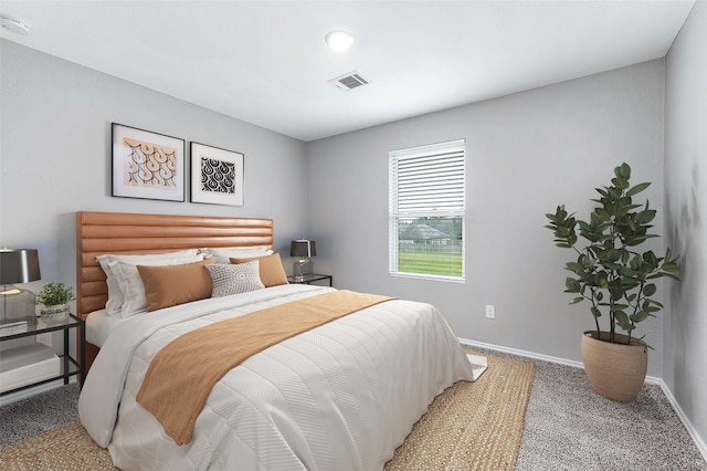 bedroom with baseboards, visible vents, and carpet flooring