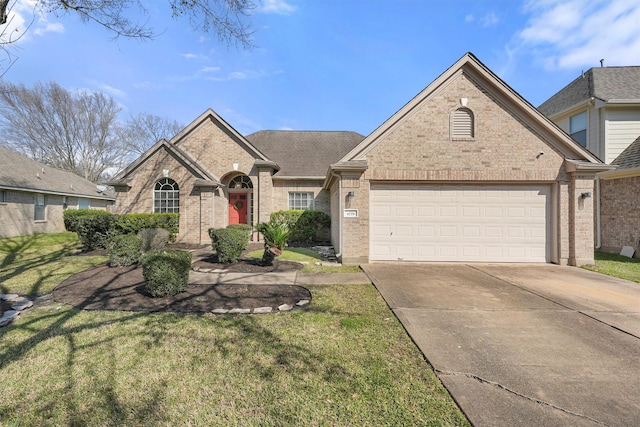 view of front facade featuring a front lawn, concrete driveway, brick siding, and an attached garage