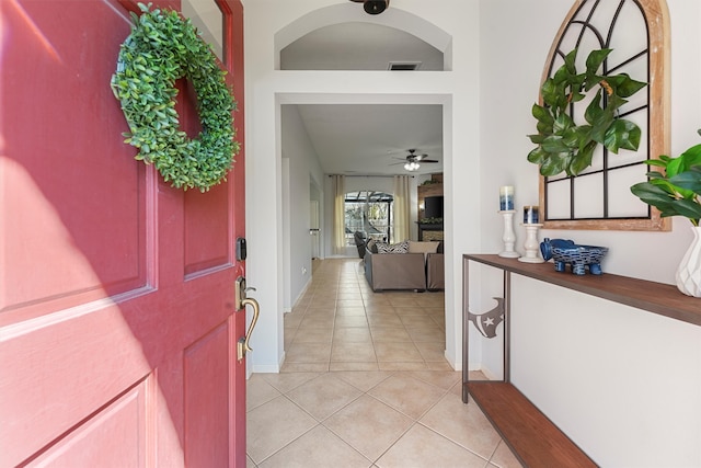 foyer entrance featuring visible vents, ceiling fan, baseboards, and light tile patterned floors