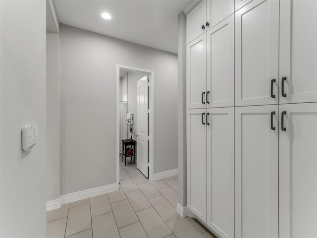 corridor with baseboards and recessed lighting