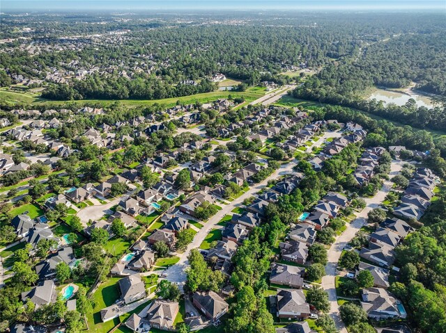 birds eye view of property featuring a residential view and a view of trees