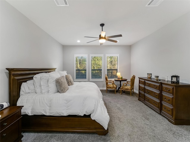 bedroom with light carpet, a ceiling fan, visible vents, and baseboards