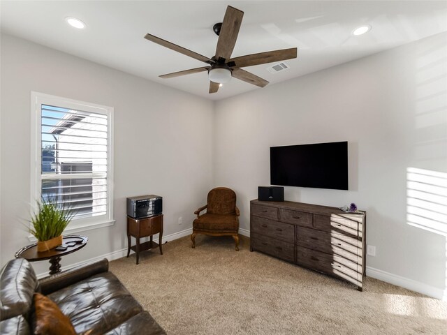 living area featuring recessed lighting, baseboards, visible vents, and light colored carpet