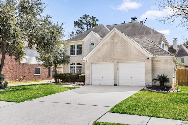 view of front of house featuring a front lawn, brick siding, and an attached garage