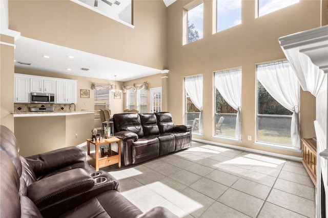 living room featuring recessed lighting, plenty of natural light, and light tile patterned floors