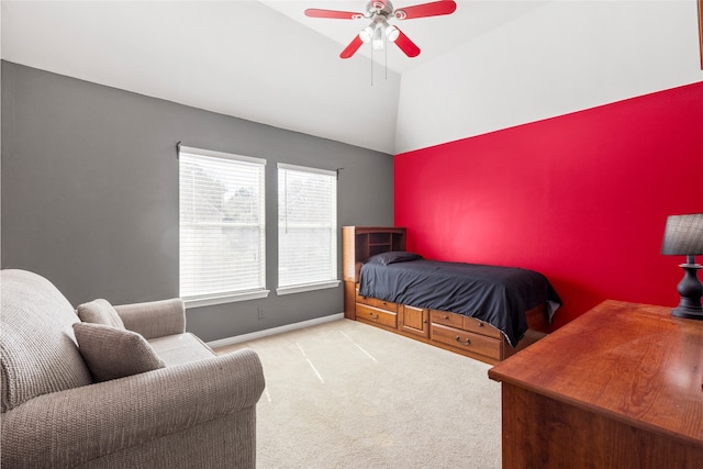 carpeted bedroom featuring vaulted ceiling, an accent wall, a ceiling fan, and baseboards