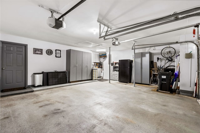 garage with freestanding refrigerator and a garage door opener