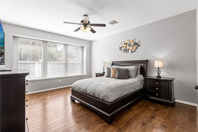 bedroom with a ceiling fan, baseboards, visible vents, and hardwood / wood-style floors