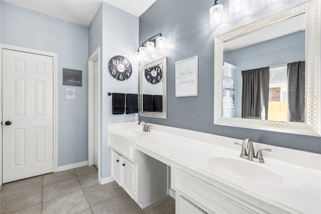 full bathroom featuring tile patterned flooring, a sink, baseboards, and double vanity