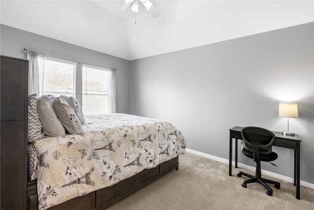 bedroom with light carpet, vaulted ceiling, a ceiling fan, and baseboards