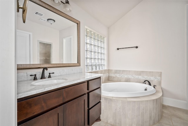 bathroom featuring lofted ceiling, visible vents, vanity, a bath, and tile patterned floors