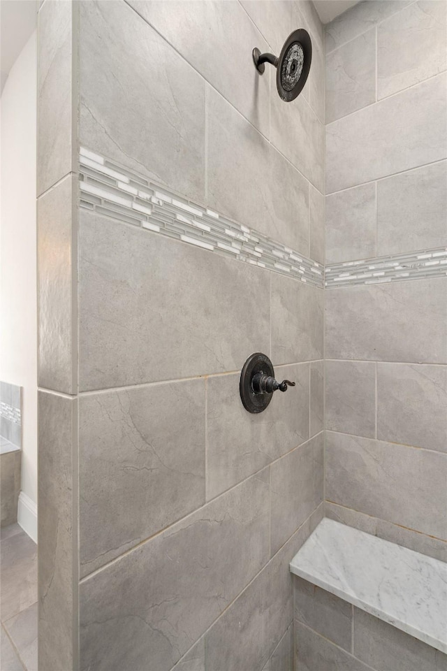 full bath with a tile shower