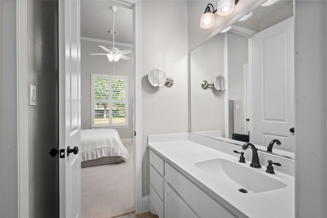 bathroom featuring ensuite bathroom, ornamental molding, and vanity