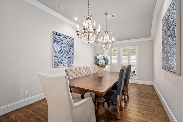 dining room featuring a notable chandelier, dark wood-type flooring, visible vents, baseboards, and crown molding