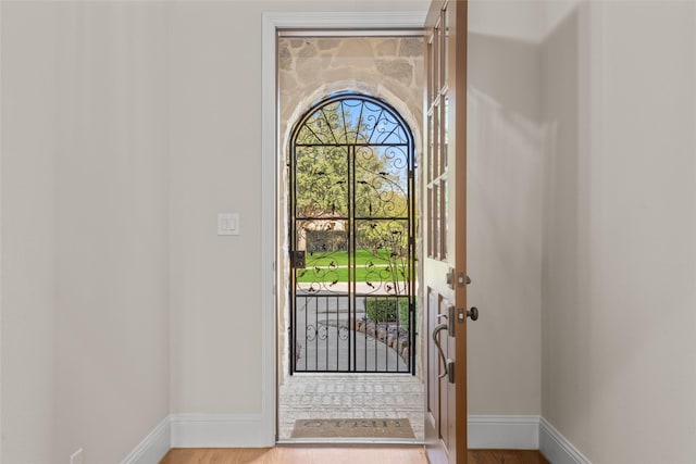 entryway featuring baseboards and wood finished floors