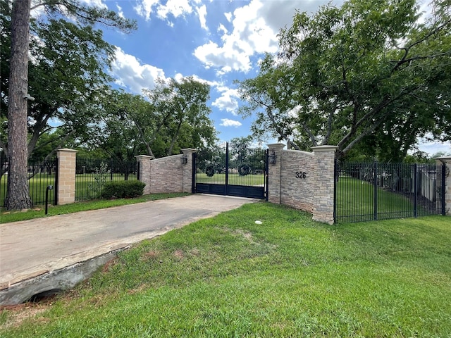 view of gate featuring a yard and a fenced front yard